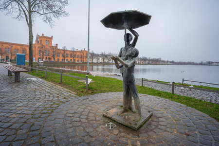 Schwerin, Germany - Jan 05, 2020: Children under an Umbrella Sculpture (Schirmkinder) by Stephan Horota - Schwerin, Germanyのeditorial素材