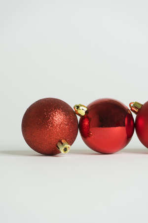 Red christmas balls white background and last shiny sphereの写真素材