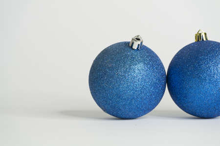 Blue christmas balls white background and last shiny sphereの写真素材