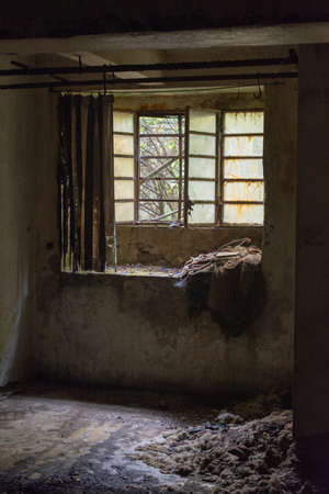 Old abandoned building dirty window in decay with broken glass and curtainの写真素材