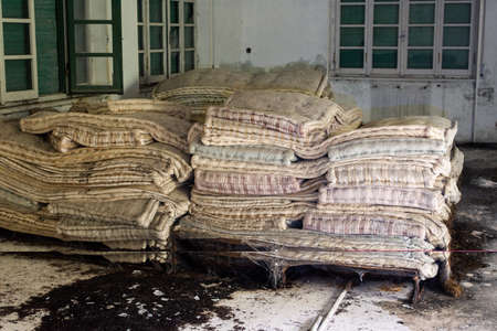 Old abandoned and decay mattresses bed in abandoned building room in Italy house in the woodの写真素材
