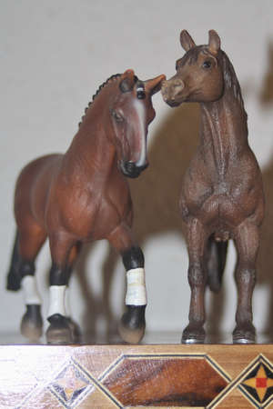 Toy horses on a chess boardの写真素材
