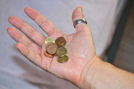 Hand holding money in times of economic crisisの写真素材