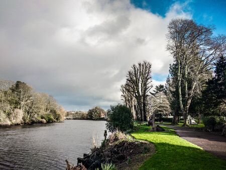 River crossing a city park on a beautiful winter dayの写真素材