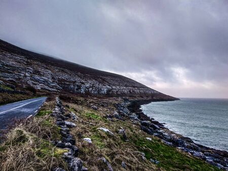 Coastal scenic road with the Atlantic Ocean in the background in a cold day of winterの写真素材