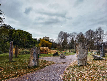 Stone circle with an ancient castle in the background in a winter dayのeditorial素材