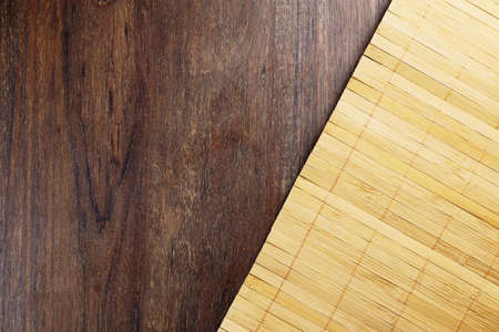 Wood texture. Rustic wood with a mat of light wooden chopsticks. Top view.