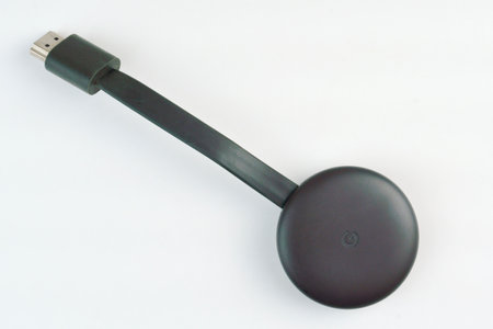Google Chromecast 3rd generation close-up isolated on white background. Selective focus. Top view....