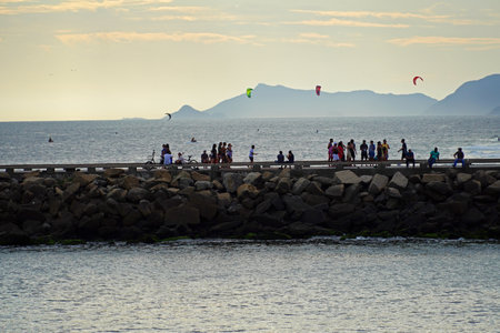 Barra da Tijuca beach on a sunny day with people enjoying the sand and the sea. View of the breakwater, Barra channel and Praia dos Amores. Rio de Janeiro, RJ, Brazil. January 2021.のeditorial素材