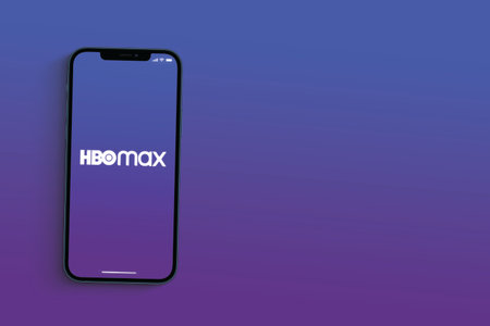 Hbo Max app on the smartphone screen on blue background. App for movies and TV series via streaming. Rio de Janeiro, RJ, Brazil. June 2021.のeditorial素材