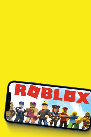 Roblox game app on the smartphone screen on yellow background. Top view. Rio de Janeiro, RJ, Brazil. June 2021.のeditorial素材