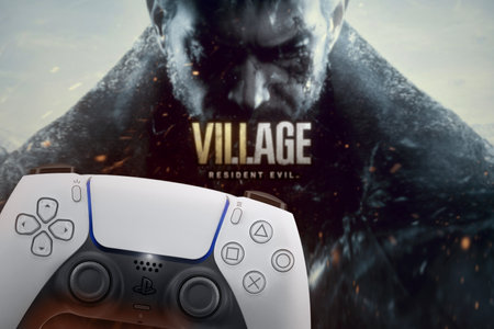 Playstation 5 Dual Sense controller with Resident Evil Village game blurred in the background. Rio...