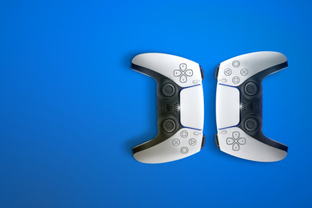 2 Playstation 5 Dual Sense controllers on blue background. Top view and space for text. Rio de...