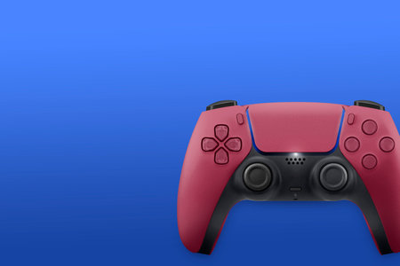 Next Generation red game controller isolated on blue background. Top view.の写真素材