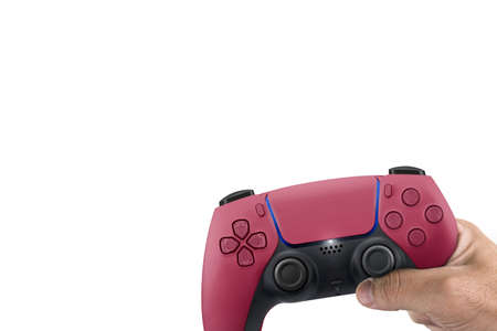 Male hand holding a Next Generation red game controller isolated on white background.