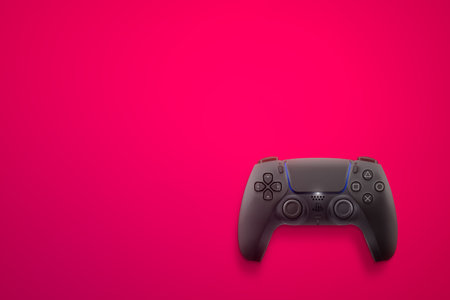 Playstation 5 Dual Sense black controller isolated on pink background. Top view. Rio de Janeiro, RJ, Brazil. June 2021.のeditorial素材