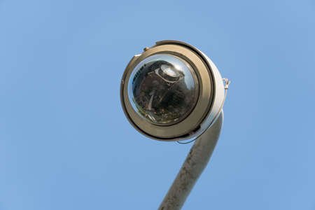 Outdoor CCTV security camera installed on pole in city.