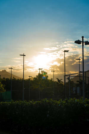 Beautiful late afternoon in the city of Rio de Janeiro. Sky and blue and orange with the sun setting in the background. Sunset at the park in Rio de Janeiro, Brazil.の写真素材