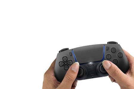Female hand holding a Next Generation black game controller isolated on white background.