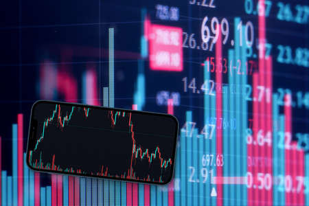 A smartphone with financial stock market graph. Stock Exchange. Graphics in the background.
