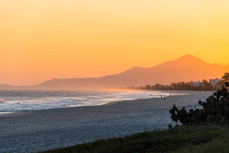 Sunset at Saquarema beach in Rio de Janeiro, Brazil. Famous for waves and surfing. Church on top of the hill.の写真素材