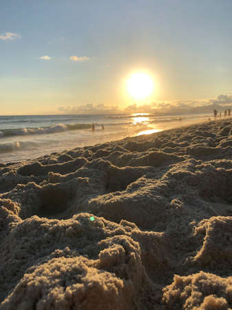 Sunset at Barra da Tijuca beach in Rio de Janeiro, Brazil. Sea with calm waves.の写真素材