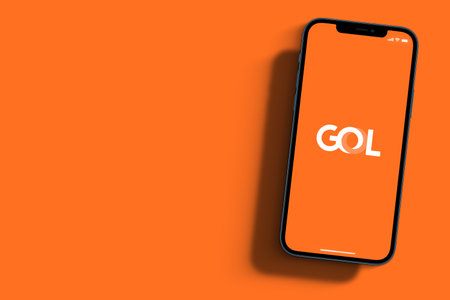 Goal Airlines app on smartphone screen on orange background. Rio de Janeiro, RJ, Brazil. September 2021.のeditorial素材