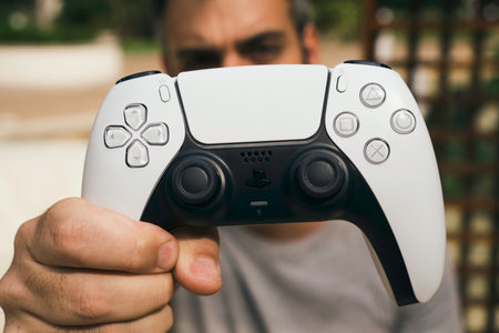 Man holding the Playstation 5 Dual Sense Controller. Rio de Janeiro, RJ, Brazil. September 2021.のeditorial素材