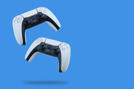 Playstation 5 Dual Sense Controllers falling on blue background. Rio de Janeiro, RJ, Brazil....
