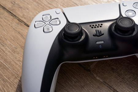 Playstation 5 Dual Sense controller isolated on wooden background. Natural light. Selective focus....