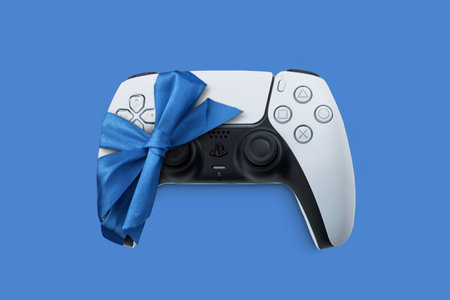 Playstation 5 Dual Sense controller gift-wrapped with ribbon. Ideal as a gift from Santa Claus at...