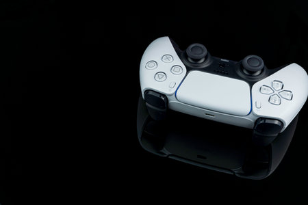 Playstation 5 Dual Sense controller isolated on black background with reflection. Selective focus....