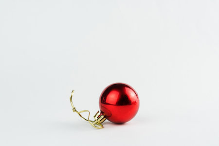 Christmas ornament isolated on white background. Polka dots to hang on Christmas trees to celebrate the arrival of Santa Claus. Red ball.の写真素材