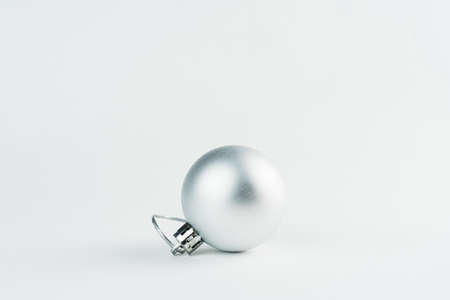 Christmas ornament isolated on white background. Polka dots to hang on Christmas trees to celebrate the arrival of Santa Claus. Silver ball.の写真素材