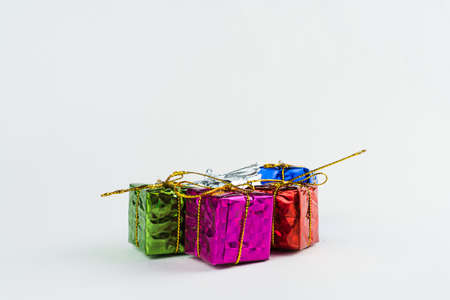 Christmas ornament isolated on white background. Mini gift boxes to hang on Christmas trees to celebrate the arrival of Santa Claus. Different color boxes.の写真素材