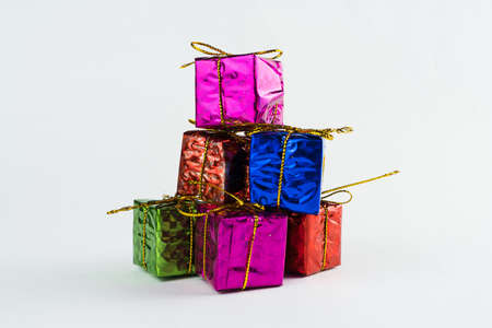 Christmas ornament isolated on white background. Mini gift boxes to hang on Christmas trees to celebrate the arrival of Santa Claus. Different color boxes.の写真素材