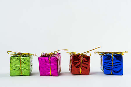 Christmas ornament isolated on white background. Mini gift boxes to hang on Christmas trees to celebrate the arrival of Santa Claus. Different color boxes.の写真素材
