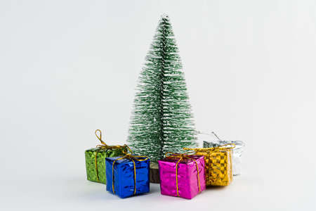 Christmas ornament isolated on white background. Mini Christmas tree with some small gift boxes on the side to celebrate the arrival of Santa Claus.の写真素材