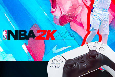 Playstation 5 Dual Sense Controller with NBA 2k22 Basketball game blurred in the background. Rio de...