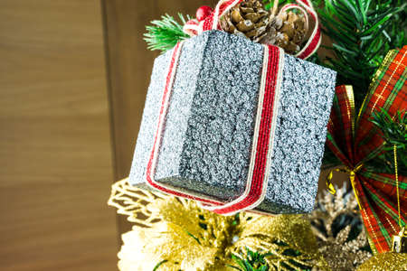 Christmas tree assembled with ornaments. Red, silver and gold balls, gift boxes, lights, Santa Claus and others. Selective focus.の写真素材