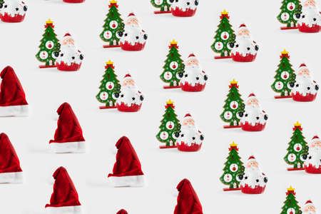 Pattern with Christmas ornaments including Santa Claus, Christmas tree and Santa's cap on white background.の写真素材