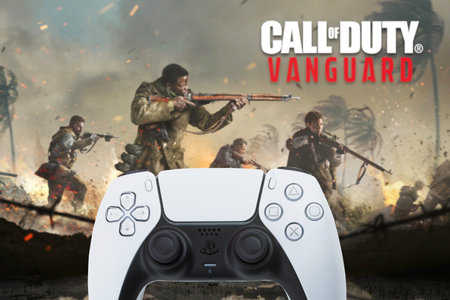 Playstation 5 Dual Sense Controller with Call of Duty Vanguard game blurred in the background. Rio...