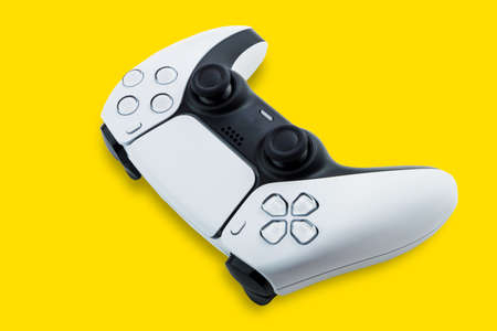 Next Generation white game controller isolated on yellow background. Top view.