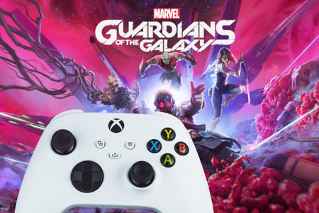 Xbox Series S Robot White Controller with Marvel Guardians of the Galaxy game blurred in the...