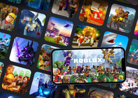 Roblox mobile game app on iPhone 13 Pro smartphone screen with the game blurred on background. Rio de Janeiro, RJ, Brazil. October 2021.のeditorial素材