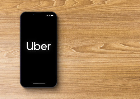Uber app on smartphone iPhone 13 Pro screen on wooden background. Rio de Janeiro, RJ, Brazil. November 2021.のeditorial素材