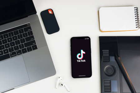 Tik Tok app on the smartphone screen on white background table. Office environment. Rio de Janeiro, RJ, Brazil. January 2022.のeditorial素材