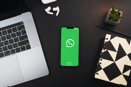 WhatsApp app on the smartphone screen on black background table. Office environment. Rio de Janeiro, RJ, Brazil. January 2022.のeditorial素材