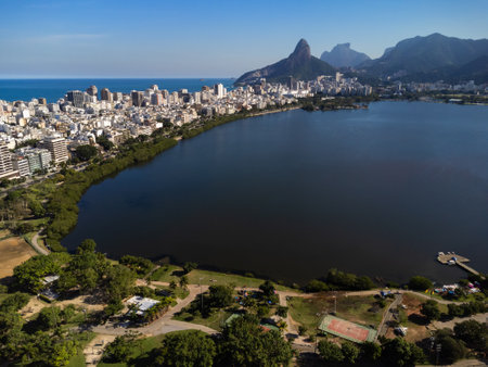Aerial view of Rodrigo de Freitas Lagoon, south zone of Rio de Janeiro, Brazil. In the background, the beaches of Ipanema and Leblon. Sunny day. Cars traveling on Avenida EpitÃ¡cio Pessoa. Drone photo.の写真素材