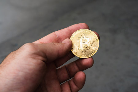 Closeup of golden Bitcoin, Ethereum and Solana coins on a rustic wooden table. Cryptocurrency...